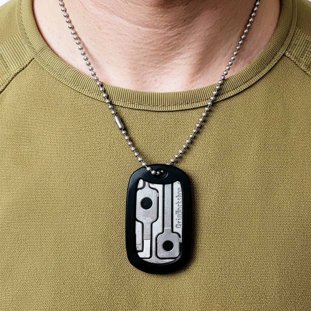 Close up of escape dog tag showing removable handcuff key, shim, and file.