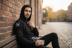 Hoodie with hidden pockets used to carry flat survival tools and small tins discreetly.