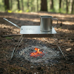 Packable griddle placed on a compact stove setup outdoors.