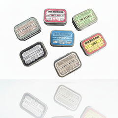 Pak kits positioned in belt buckle, stash patch, and micro survival tin showing distributed compact carry.